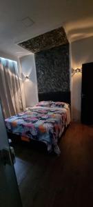 a bedroom with a bed with a quilt on it at flat Luiz Carlos Mouzinho in Teresina
