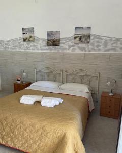 a bedroom with a large bed with two pillows at B&B Pietrafitta in Carovigno