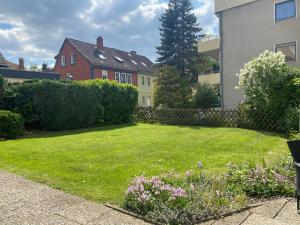 a yard with green grass and a house at Ferienwohnung Univers 3 in Bad Harzburg