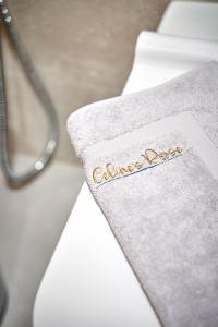 a towel with the word cancerdose sitting on a bed at Celine's Rose in Skala Potamias