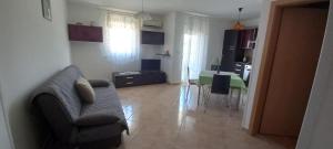 a living room with a couch and a dining room at Apartments Buzleta II in Fažana