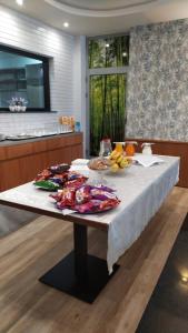 a table with fruits and vegetables on it in a kitchen at Luander Hotel in Tirana