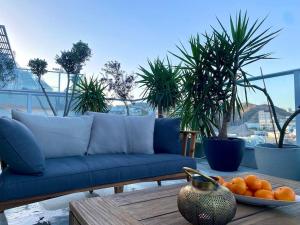 a blue couch and a plate of oranges on a table at Spa Eilat Mountain Lodge in Eilat