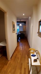 a living room with a hard wood floor and a hallway at La casa di Sacco - Appartamento Bologna Centro in Bologna