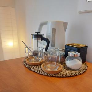 a tray with glasses and a coffee maker on a table at Guest House Mediterranean in Hvar