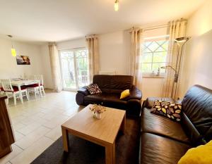 a living room with a couch and a table at Quartier4u - 4 Sterne - inklusive eigene BikeBox mit Strom - Wäschepaket - POWER WLAN - Parkplatz - early CheckIn - # Bestpreisgarantie # in Zingst