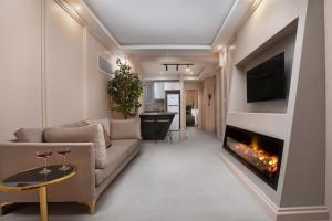 a living room with a couch and a fireplace at Walton Gardens Pera in Istanbul