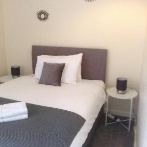 a bedroom with a bed with two speakers on it at Marshfield Apartment in Goole