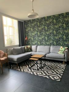 a living room with a couch and a table at Anna Place in Ghent +2 photos