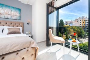 a bedroom with a bed and a table with a chair at Boutique Residence Arion in Rovinj