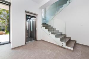 a staircase in a house with a glass wall at Boutique Residence Arion in Rovinj