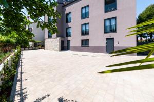a building with a brick driveway in front of a building at Boutique Residence Arion in Rovinj