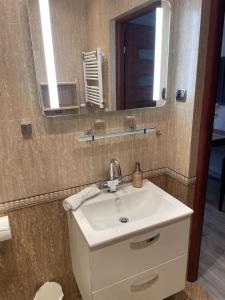 a bathroom with a sink and a mirror at Apartment GYNA - Promenade - Strandnah in Świnoujście