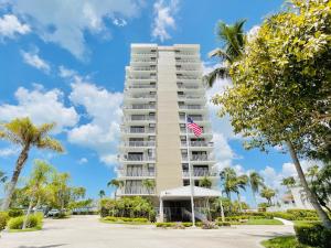 a tall apartment building with an american flag on it at #808 Gulf View at Lovers Key Beach Club in Fort Myers Beach