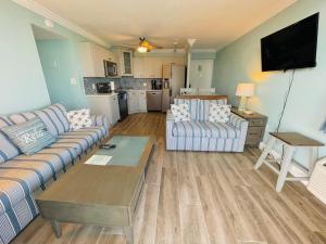 a living room with a couch and a table at #1104 Lovers Key Beach Club Ocean Front in Fort Myers Beach