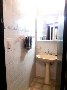 a white bathroom with a sink and a mirror at Casa Don Octavio in San Fernando del Valle de Catamarca +14 photos