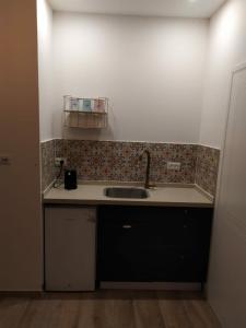 a kitchen with a sink and a counter top at מדבריות השחר in Dimona