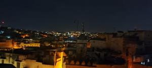a view of a city at night at Dar Ouassim in Fez