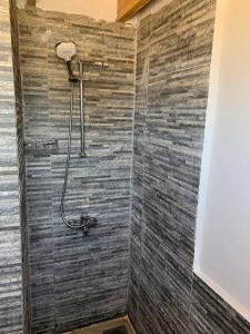 a bathroom with a shower with a wooden wall at Habiba Beach Lodge in Nuweiba +58 photos