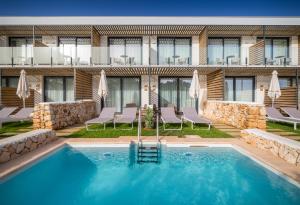 a swimming pool in the middle of a hotel at Barceló Nura in Sant Lluis