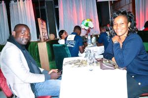 a man and a woman sitting at a table at Résidence L'écrin in Yaoundé