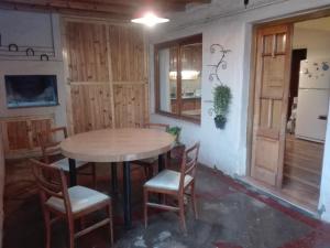a kitchen with a table and chairs in a room at Hostel San Juan 653 Dpto 3 in San Rafael