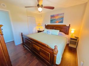 a bedroom with a bed and a ceiling fan at #901 Private Beach and Gulf Views in Fort Myers Beach
