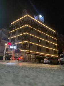 a hotel building with a car parked in front of it at My Rezidance Hotel in Manisa