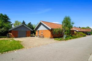 a brick house with a garage and a driveway at 1 private room in Billund in Billund