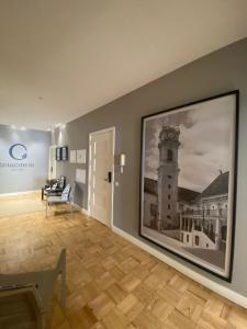 a room with a large picture of a clock tower at Casa dos Carvalhos in Coimbra