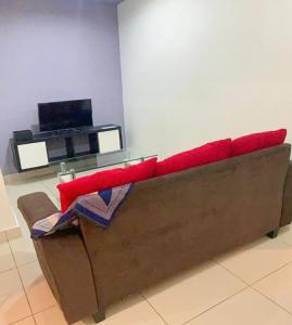a couch sitting in a room with a television at Mansion One Seaview Luxury 2 Bedroom Gurney Georgetown gleneagles in George Town