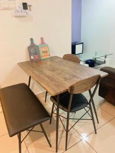 a wooden table and two chairs in a room at Mansion One Seaview Luxury 2 Bedroom Gurney Georgetown gleneagles in George Town