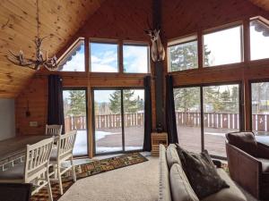 a living room with large windows and a couch at Wildlife Chalet - Sauna Lakeview Firepit Wifi in Tofte