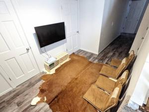 sala de estar con mesa, sillas y TV en Wildlife Chalet - Sauna Lakeview Firepit Wifi, en Tofte