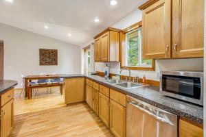 a kitchen with wooden cabinets and a sink at Westport Hideout in Westport