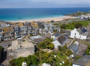 an aerial view of a town with a beach at Ayr Farmhouse in St Ives