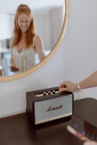 a woman is standing in front of a mirror at White Sands Hotel in Honolulu +82 photos