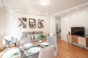 a living room with a couch and a table at EnjoyGranada PLAZA NUEVA HOMES in Granada