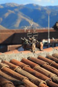 
a man standing on top of a pile of logs at Hotel & Mirador Los Apus by DOT Tradition in Cusco
