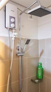 a shower in a bathroom with a shower head at StayInMyCondo - 30th Condo in Pasay with Pool near Airport MOA,CCP & PICC In Pasay in Manila