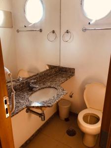 a bathroom with a sink and a toilet at Classic Flat do Eduardo in São Paulo