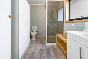 a bathroom with a sink, toilet, and bathtub at Blackwood Park Cottages Mole Creek in Mole Creek