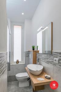 a white bathroom with a sink and a toilet at Grey House in La Spezia