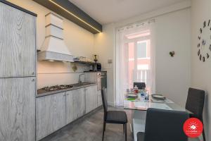 a kitchen with a table and a stove top oven at Grey House in La Spezia