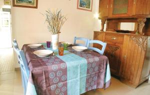 a dining room table with a table cloth on it at Awesome Home In St, Hilaire De Riez With 2 Bedrooms in Saint-Hilaire-de-Riez