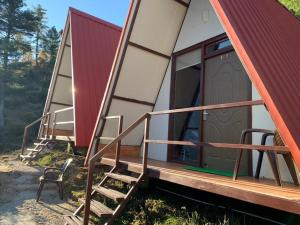 a group of modular homes with a door and a ladder at Cottages Amid Mountains in Joshīmath