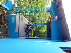 a blue door with a view of a staircase at Pacific Bay Resort in Boca Chica