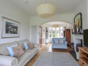 a living room with a couch and two chairs at Summerfield in Conwy