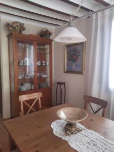 a dining room with a wooden table and a dining room at Casa Rural Casa Sagasta in Elche de la Sierra