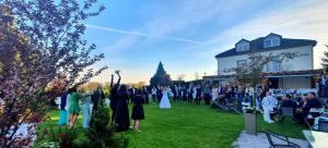 Eine Gruppe von Menschen, die auf einer Hochzeit im Gras stehen in der Unterkunft Hotel BRADA in Jičín